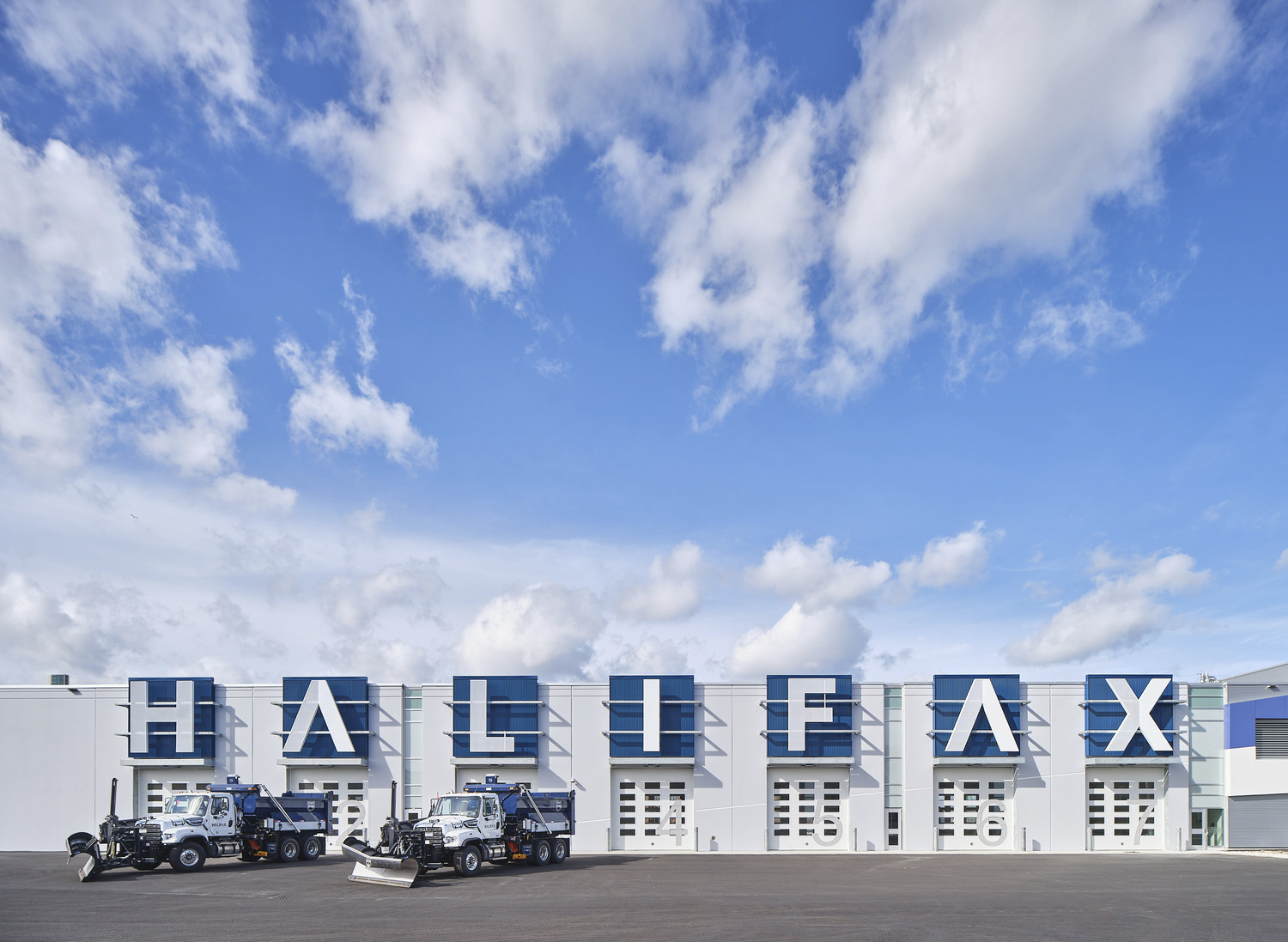 White building with large blue letters spelling 