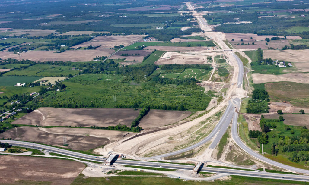 An aerial view of a highway over a field.
