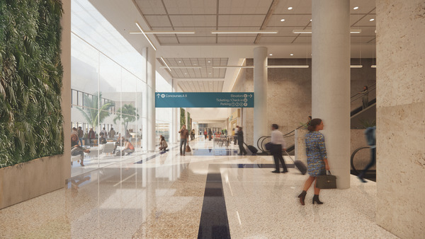 Spacious small and medium hub airport terminal with large windows, an indoor green wall, people walking, and directional signs for departures, ticketing, and restrooms.