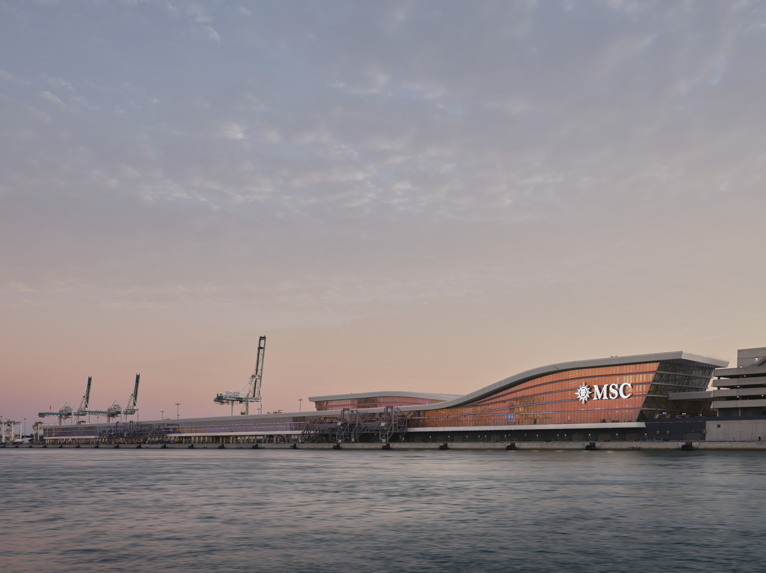 Modern cruise terminal building with large glass windows and 