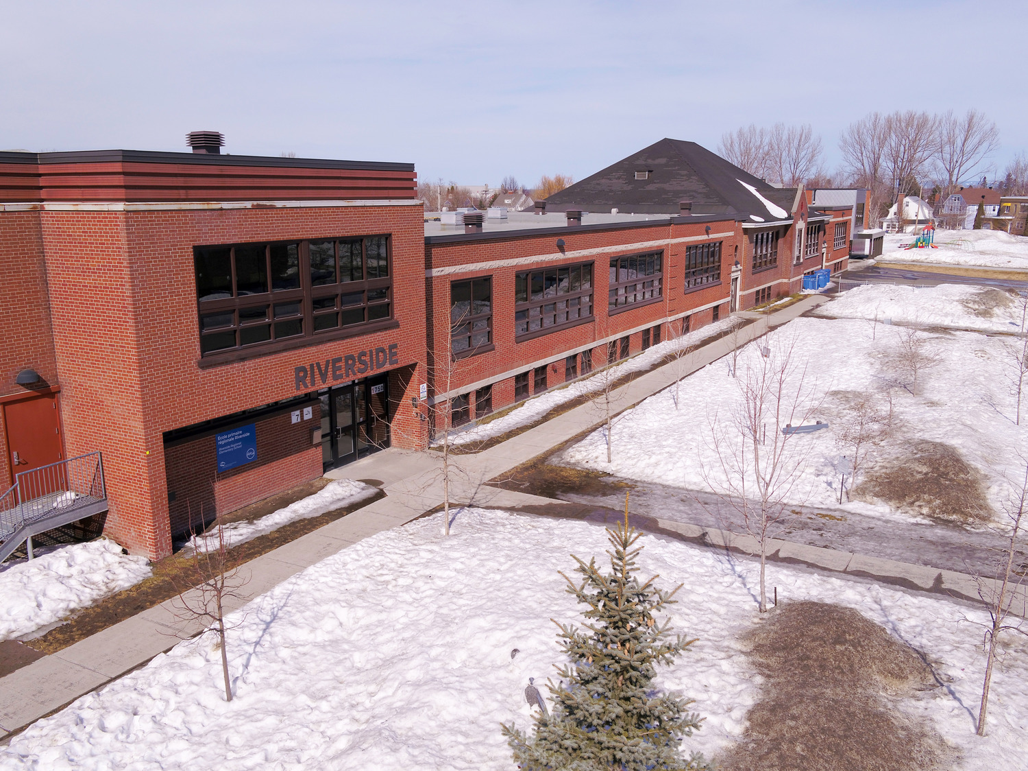 A two-story brick building labeled 