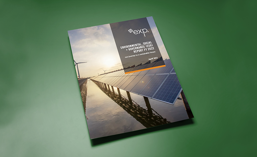 A report on "Environmental, Social & Governance (ESG) Framework FY 2023" from a company named "exp." is placed on a green surface. The cover features images of solar panels and a wind turbine.